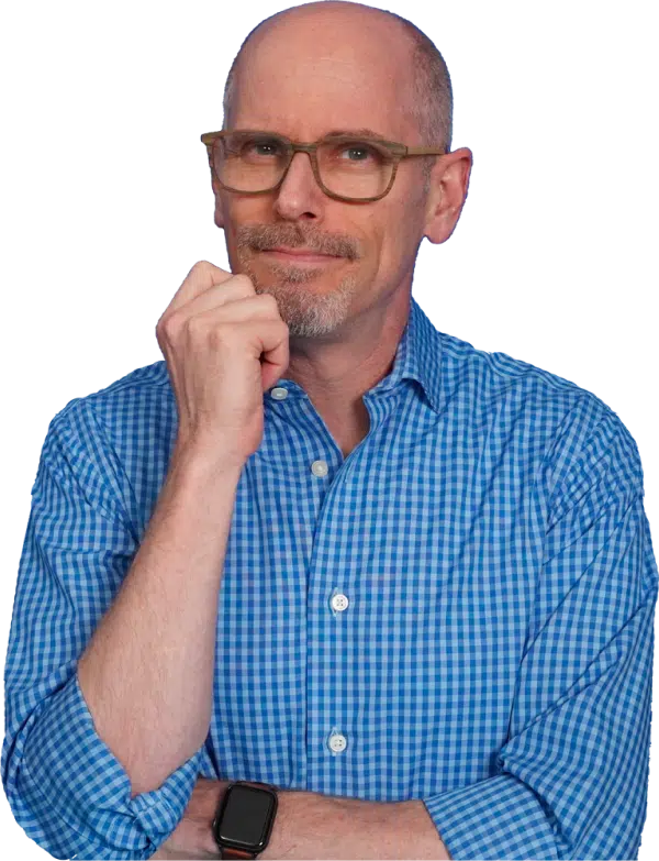 Eric McDermott in a blue gingham shirt, hand to his chin, on a transparent background.